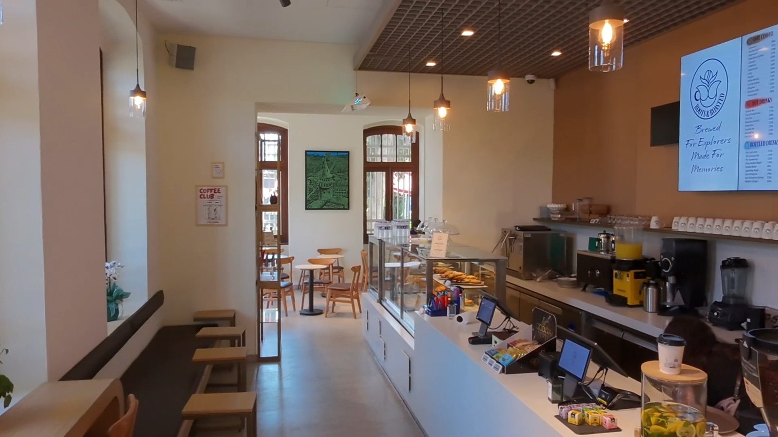 The counter, pastry case and menu board inside Roots & Roasted